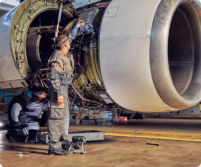 Mechanics performing maintenance on a jet engine